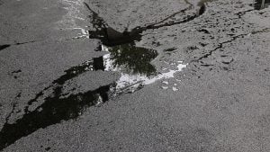 dangers of standing water on asphalt surface 
